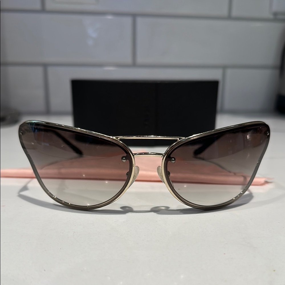 Prada PR74VS sunglasses butterfly silhouette with a metallic gold frame. - Picture 4 of 12